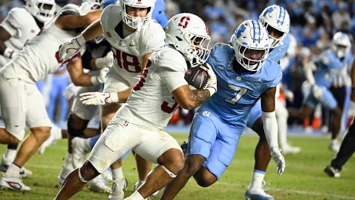 Nov 8, 2025; Chapel Hill, North Carolina, USA;  Stanford Cardinal running back Cole Tabb (33) with the ball as North Carolina Tar Heels linebacker Khmori House (7) defends in the third quarter at Kenan Stadium. Mandatory Credit: Bob Donnan-Imagn Images
