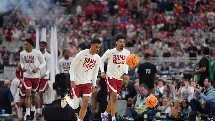 Apr 6, 2024; Glendale, AZ, USA; Alabama Crimson Tide runs onto the court to warmup before the semifinals of the men's Final Four of the 2024 NCAA Tournament against the Connecticut Huskies at State Farm Stadium. Mandatory Credit: Bob Donnan-Imagn Images