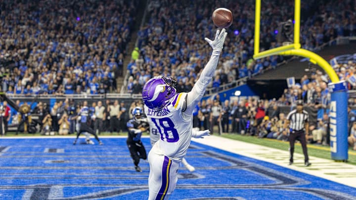 Jan 5, 2025; Detroit, Michigan, USA; Minnesota Vikings wide receiver Justin Jefferson (18) attempts to pull in a pass in front of Detroit Lions cornerback Amik Robertson (21) during the first half at Ford Field.