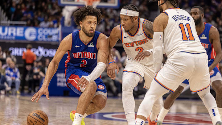 Detroit Pistons guard Cade Cunningham controls the ball next to New York Knicks guard Miles McBride during the second half at Little Caesars Arena. Mandatory Credit: David Reginek-Imagn Images