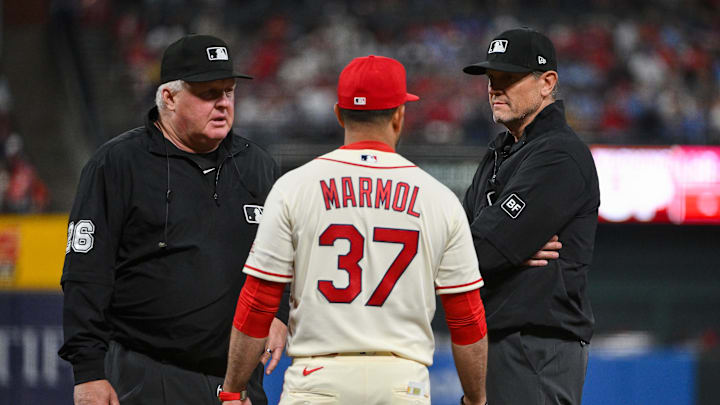 Apr 11, 2026; St. Louis, Missouri, USA; St. Louis Cardinals manager Oliver Marmol (37) talks with umpire Bill Miller (26) and umpire Chad Fairchild (4) about challenging a catchers interference call during the seventh inning at Busch Stadium. Mandatory Credit: Jeff Curry-Imagn Images