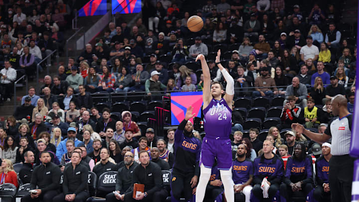 Dec 13, 2024; Salt Lake City, Utah, USA; Utah Jazz center Walker Kessler (24) makes a three point shot in front of the Phoenix Suns bench during the first quarter at Delta Center. Mandatory Credit: Rob Gray-Imagn Images