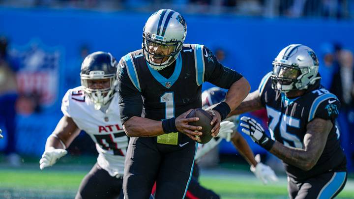 Carolina Panthers quarterback Cam Newton (1) is chased out of the pocket by the Atlanta Falcons defense Carolina Panthers quarterback Cam Newton (1) is chased out of the pocket by the Atlanta Falcons defense
