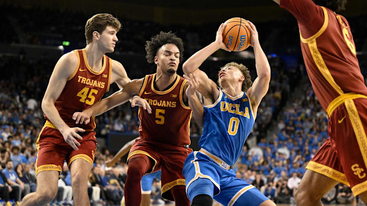 Feb 24, 2026; Los Angeles, California, USA; UCLA Bruins guard Trent Perry (0) drives to the basket past Southern California Trojans center Gabe Dynes (45), Terrance Williams II (5) and Jacob Cofie (6) during the 2nd half at Pauley Pavilion presented by Wescom Financial. Mandatory Credit: Robert Hanashiro-Imagn Images Feb 24, 2026; Los Angeles, California, USA; UCLA Bruins guard Trent Perry (0) drives to the basket past Southern California Trojans center Gabe Dynes (45), Terrance Williams II (5) and Jacob Cofie (6) during the 2nd half at Pauley Pavilion presented by Wescom Financial. Mandatory Credit: Robert Hanashiro-Imagn Images