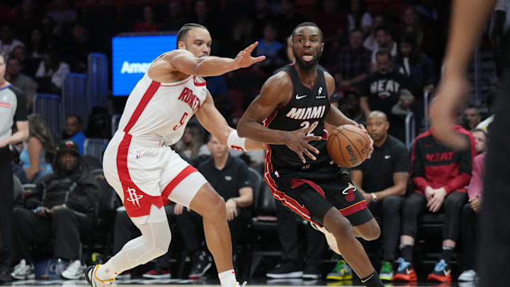 Mar 21, 2025; Miami, Florida, USA;  Miami Heat forward Andrew Wiggins (22) drives past Houston Rockets forward Dillon Brooks (9) in the second half at Kaseya Center. Mandatory Credit: Jim Rassol-Imagn Images