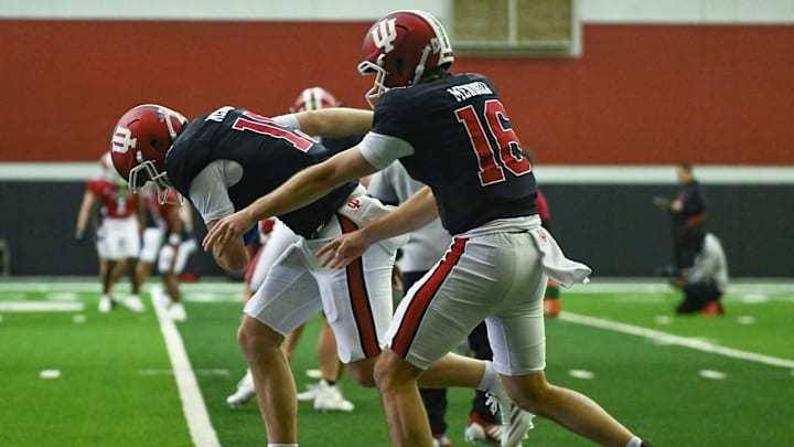Indiana’s Fernando Mendoza (15) and Alberto Mendoza (16) go through a drill during spring practice at Mellencamp Pavilion on Tuesday, April 1, 2025.