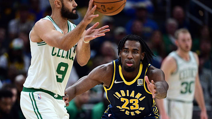 Oct 30, 2024; Indianapolis, Indiana, USA; Indiana Pacers forward Aaron Nesmith (23) defends against Boston Celtics guard Derrick White (9) during the second quarter at Gainbridge Fieldhouse. Mandatory Credit: Marc Lebryk-Imagn Images