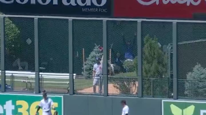 Yates made the impressive snag while warming up in the visitor's bullpen at Coors Field. 