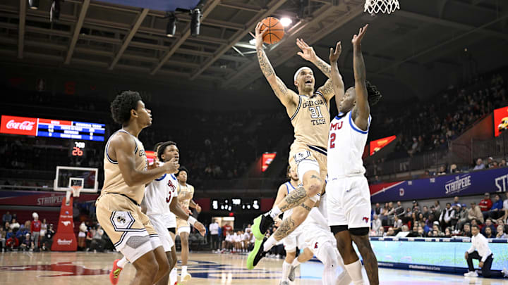 Jan 11, 2025; Dallas, Texas, USA; Georgia Tech Yellow Jackets forward Duncan Powell (31) drives to the basket past SMU Mustangs guard Boopie Miller (2) during the second half at Moody Coliseum. Mandatory Credit: Jerome Miron-Imagn Images