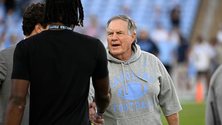 Sep 1, 2025; Chapel Hill, North Carolina, USA;  North Carolina Tar Heels head coach Bill Belichick with a recruit before the game at Kenan Stadium. Mandatory Credit: Bob Donnan-Imagn Images