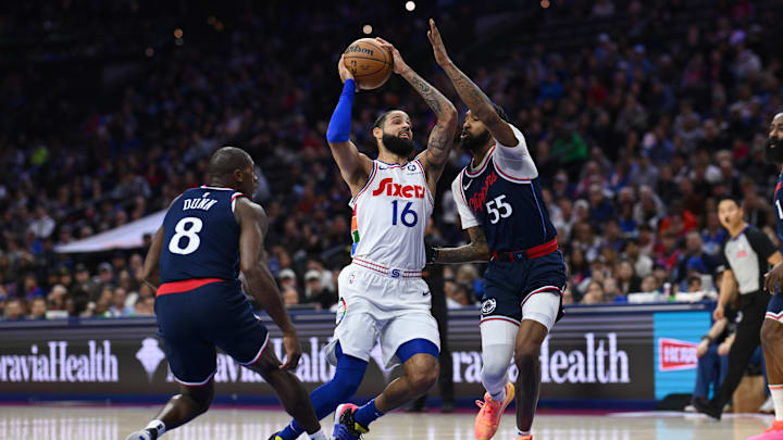 Nov 24, 2024; Philadelphia, Pennsylvania, USA; Philadelphia 76ers forward Caleb Martin (16) drives against Los Angeles Clippers forward Derrick Jones Jr (55) and guard Kris Dunn (8) in the first quarter at Wells Fargo Center. Mandatory Credit: Kyle Ross-Imagn Images