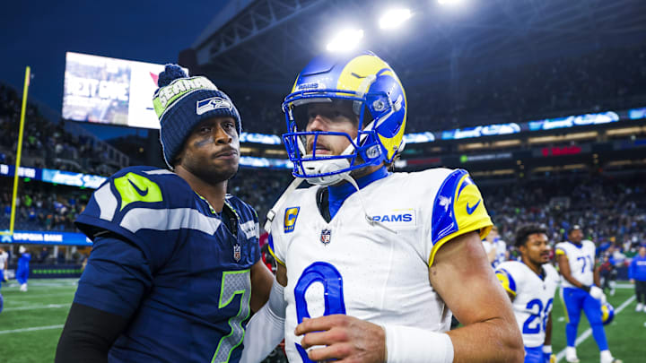 Nov 3, 2024; Seattle, Washington, USA; Seattle Seahawks quarterback Geno Smith (7) and Los Angeles Rams quarterback Matthew Stafford (9) greet each other following an overtime victory by the Rams at Lumen Field. Mandatory Credit: Joe Nicholson-Imagn Images