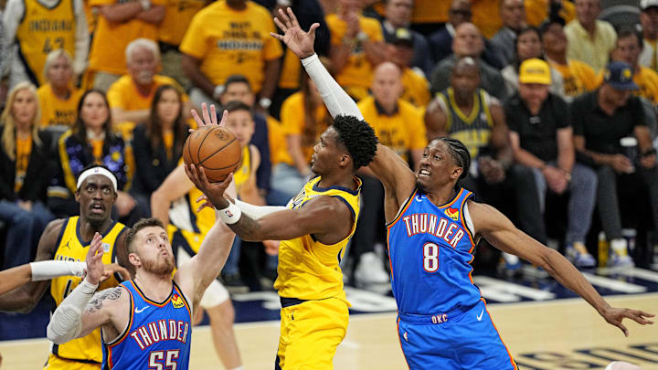 Jun 11, 2025; Indianapolis, Indiana, USA; Indiana Pacers guard Bennedict Mathurin (00) shoots the ball against Oklahoma City Thunder center Isaiah Hartenstein (55) and forward Jalen Williams (8) during the fourth quarter in game three of the 2025 NBA Finals at Gainbridge Fieldhouse. Mandatory Credit: Kyle Terada-Imagn Images