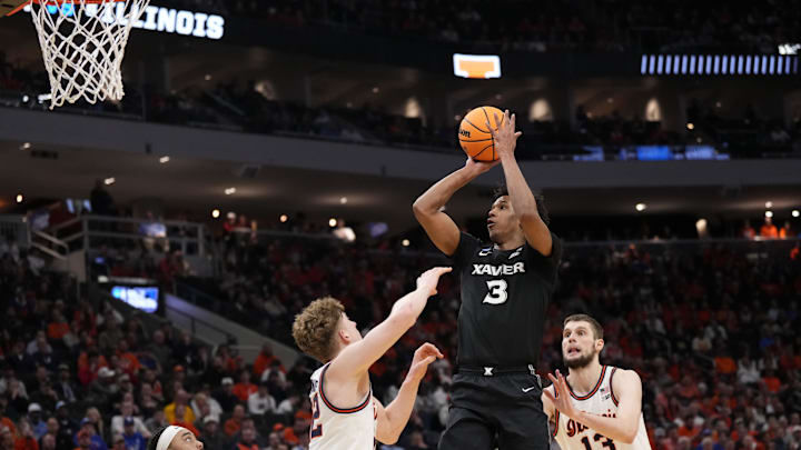 Mar 21, 2025; Milwaukee, WI, USA: Xavier Musketeers guard Dailyn Swain (3) shoots a layup past Illinois Fighting Illini guard Kasparas Jakucionis (32) during the second half at Fiserv Forum.