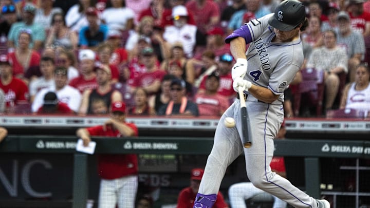 Jul 12, 2025; Cincinnati, Ohio, USA;  Colorado Rockies first baseman Michael Toglia (4) gets a base hit in the ninth inning against the Cincinnati Reds in the ninth inning at Great American Ball Park. Mandatory Credit: Albert Cesare/The Cincinnati Enquirer-Imagn Images
