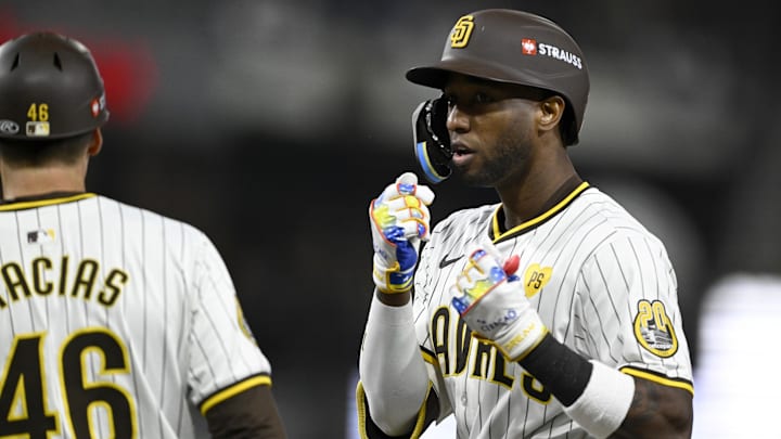 Oct 9, 2024; San Diego, California, USA; San Diego Padres outfielder Jurickson Profar (10) celebrates with first base coach David Macias (46) after hitting a single in the eighth inning against the Los Angeles Dodgers during game four of the NLDS for the 2024 MLB Playoffs at Petco Park.  Mandatory Credit: Denis Poroy-Imagn Images