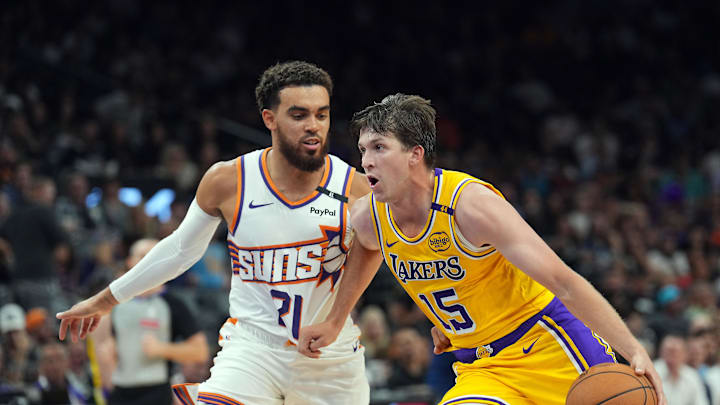 Oct 17, 2024; Phoenix, Arizona, USA; Los Angeles Lakers guard Austin Reaves (15) dribbles against Phoenix Suns guard Tyus Jones (21) during the second half at Footprint Center. Mandatory Credit: Joe Camporeale-Imagn Images