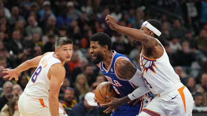 Nov 4, 2024; Phoenix, Arizona, USA; Philadelphia 76ers forward Paul George (8) dribes against Phoenix Suns guard Bradley Beal (3) and Phoenix Suns guard Grayson Allen (8) during the second half at Footprint Center. Mandatory Credit: Joe Camporeale-Imagn Images