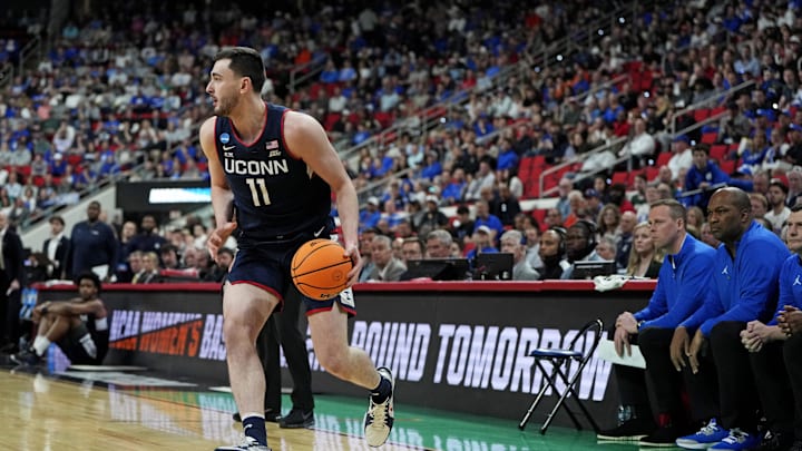 Mar 23, 2025; Raleigh, NC, USA; Connecticut Huskies forward Alex Karaban (11) drives to the basket during the first half against the Florida Gators in the second round of the NCAA Tournament at Lenovo Center. Mandatory Credit: Bob Donnan-Imagn Images Mar 23, 2025; Raleigh, NC, USA; Connecticut Huskies forward Alex Karaban (11) drives to the basket during the first half against the Florida Gators in the second round of the NCAA Tournament at Lenovo Center. Mandatory Credit: Bob Donnan-Imagn Images