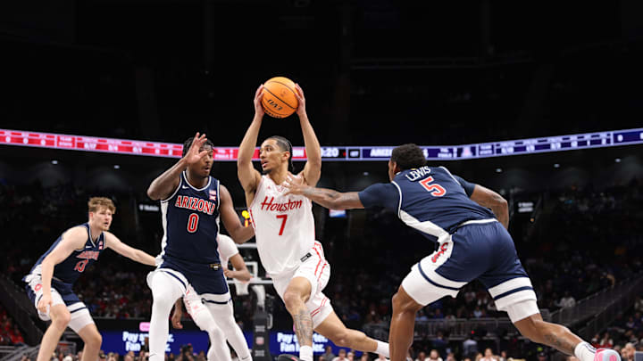 Mar 15, 2025; Kansas City, MO, USA; Houston Cougars guard Milos Uzan (7) goes toward the basket against Arizona Wildcats guard KJ Lewis (5) during the first half for the Big 12 Conference Tournament Championship game at T-Mobile Center. Mandatory Credit: William Purnell-Imagn Images