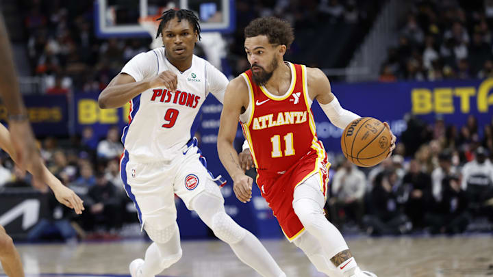 Feb 3, 2025; Detroit, Michigan, USA;  Atlanta Hawks guard Trae Young (11) dribbles defended by Detroit Pistons forward Ausar Thompson (9) in the second half at Little Caesars Arena. Mandatory Credit: Rick Osentoski-Imagn Images