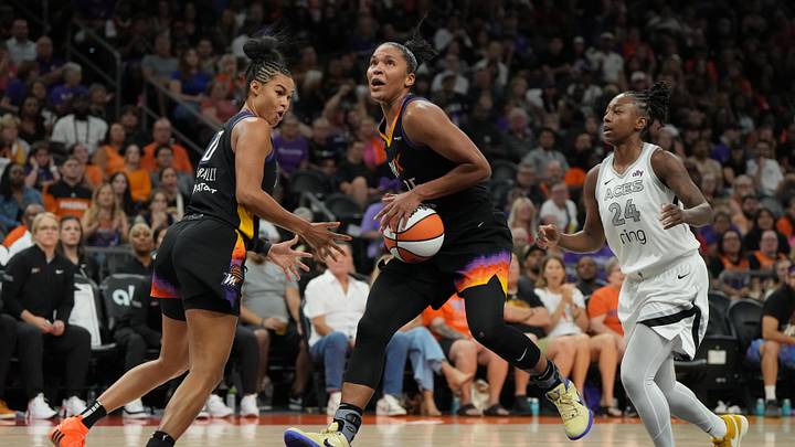 Aug 15, 2025; Phoenix, Arizona, USA; Phoenix Mercury forward Alyssa Thomas (25) drives between forward Satou Sabally (0) and Las Vegas Aces guard Jewell Loyd (24) in the second half at Footprint Center. Mandatory Credit: Rick Scuteri-Imagn Images