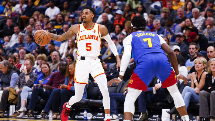 Apr 6, 2024; Denver, Colorado, USA; Atlanta Hawks guard Dejounte Murray (5) is guarded by Denver