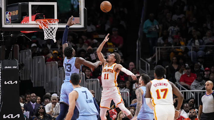 Mar 26, 2023; Atlanta, Georgia, USA; Atlanta Hawks guard Trae Young (11) shoots over top of Memphis Grizzlies forward Jaren Jackson Jr. (13) during the second half at State Farm Arena. Mandatory Credit: Dale Zanine-Imagn Images