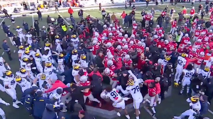 Ohio State and Michigan players fight at midfield after the Wolverines' 13-10 win over the Buckeyes at Ohio Stadium on November 30, 2024. 