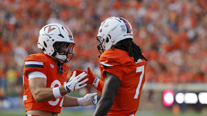Aug 30, 2025; Charlottesville, Virginia, USA; Virginia Cavaliers wide receiver Jahmal Edrine (7) celebrates with Virginia Cavaliers wide receiver Eli Wood (82) after scoring a touchdown against the Coastal Carolina Chanticleers during the second quarter at Scott Stadium. Mandatory Credit: Amber Searls-Imagn Images
