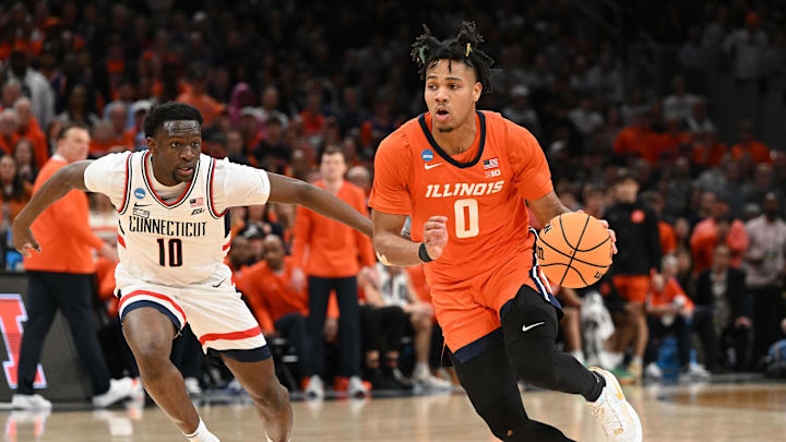 Mar 30, 2024; Boston, MA, USA; Illinois Fighting Illini guard Terrence Shannon Jr. (0) dribbles the ball against Connecticut Huskies guard Hassan Diarra (10) in the finals of the East Regional of the 2024 NCAA Tournament at TD Garden. Mandatory Credit: Brian Fluharty-USA TODAY Sports