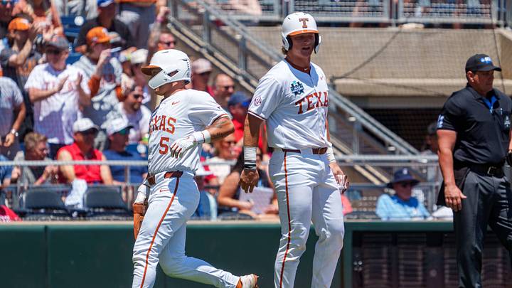 Texas Longhorns' Carson Tinney and Ethan Mendoza score on a double against the Alabama Crimson Tide in the Men's College World Series. Texas Longhorns' Carson Tinney and Ethan Mendoza score on a double against the Alabama Crimson Tide in the Men's College World Series.