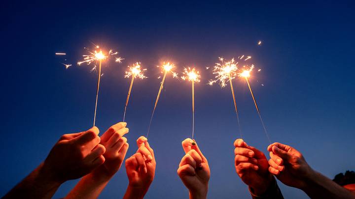 Hands holding sparklers Hands holding sparklers