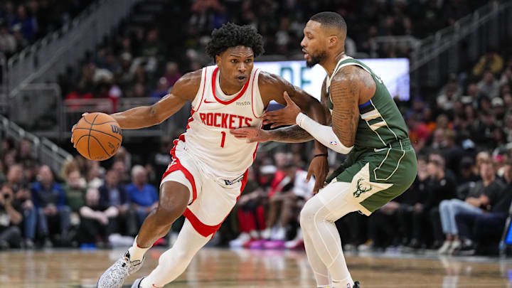 Nov 18, 2024; Milwaukee, Wisconsin, USA;  Houston Rockets guard Amen Thompson (1) drives for the basket against Milwaukee Bucks guard Damian Lillard (0) during the second quarter at Fiserv Forum. Mandatory Credit: Jeff Hanisch-Imagn Images