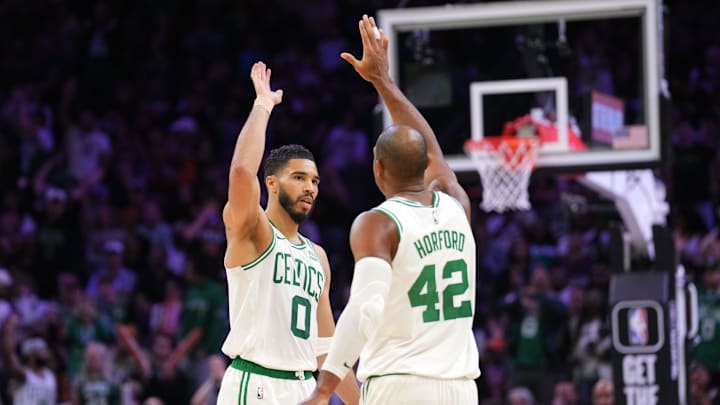 Mar 9, 2024; Phoenix, Arizona, USA; Boston Celtics forward Jayson Tatum (0) and Boston Celtics center Al Horford (42) slap hands during the second half of the game against the Phoenix Suns at Footprint Center. Mandatory Credit: Joe Camporeale-Imagn Images
