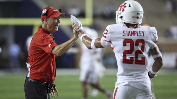 Sep 6, 2025; Houston, Texas, USA; Houston Cougars head coach Willie Fritz celebrates with defensive back Marc Stampley II (22) after a play during the fourth quarter against the Rice Owls at Rice Stadium.