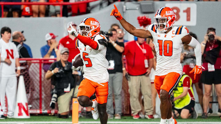Sep 20, 2024; Lincoln, Nebraska, USA; Illinois Fighting Illini defensive back Torrie Cox Jr. (5) and defensive back Miles Scott (10) celebrate after an interception in the end zone against the Nebraska Cornhuskers during the second quarter at Memorial Stadium. Mandatory Credit: Dylan Widger-Imagn Images