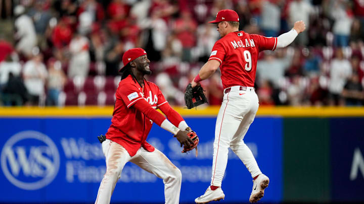 Cincinnati Reds second baseman Matt McLain (9) celebrates a win with shortstop Elly de la Cruz (44) after the ninth inning of the MLB National League game between the Cincinnati Reds and the Colorado Rockies at Great American Ball Park in downtown Cincinnati on Tuesday, April 28, 2026. The Reds won the opening game of the series, 7-2.