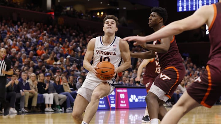 Feb 1, 2025; Charlottesville, Virginia, USA; Virginia Cavaliers guard Taine Murray (10) controls the ball as Virginia Tech Hokies guard Tyler Johnson (10) defends during the second half at John Paul Jones Arena. Mandatory Credit: Amber Searls-Imagn Images