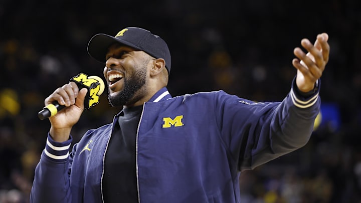 Jan 19, 2025; Ann Arbor, Michigan, USA;  Michigan Wolverines head football coach Sherrone Moore fires up the crowd in overtime of the basketball game against the Northwestern Wildcats at Crisler Center. Mandatory Credit: Rick Osentoski-Imagn Images