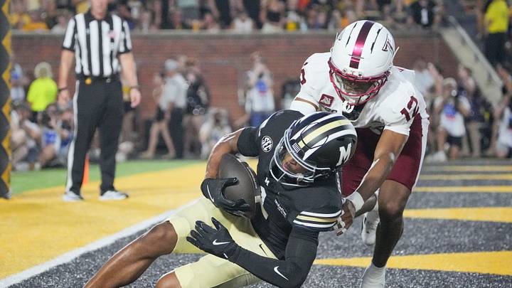 Sep 19, 2026; Columbia, Missouri, USA; Missouri Tigers wide receiver Donovan Olugbode (1) catches a pass for a touchdown as Troy Trojans cornerback Shemar Welch (12) attempts the tackle during the first half of the game at Faurot Field at Memorial Stadium. Mandatory Credit: Denny Medley-Imagn Images Sep 19, 2026; Columbia, Missouri, USA; Missouri Tigers wide receiver Donovan Olugbode (1) catches a pass for a touchdown as Troy Trojans cornerback Shemar Welch (12) attempts the tackle during the first half of the game at Faurot Field at Memorial Stadium. Mandatory Credit: Denny Medley-Imagn Images