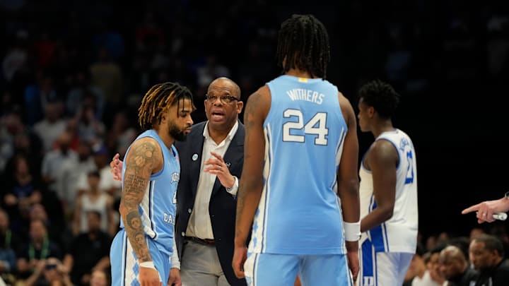 Mar 14, 2025; Charlotte, NC, USA; North Carolina Tar Heels head coach Hubert Davis talks with guard RJ Davis (4) as forward Jae'Lyn Withers (24) looks on in the second half at Spectrum Center. 