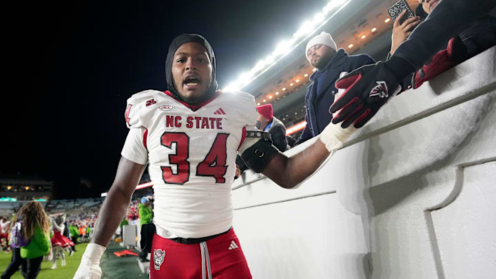 Nov 30, 2024; Chapel Hill, North Carolina, USA; North Carolina State Wolfpack linebacker Kamal Bonner (34) celebrates after the game at Kenan Memorial Stadium. Mandatory Credit: Bob Donnan-Imagn Images