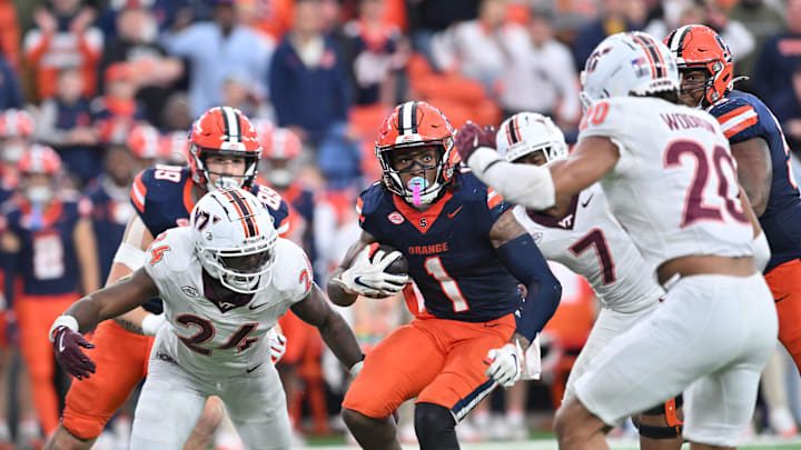 Syracuse running back LeQuint Allen tries to avoid Virginia Tech linebackers Jaden Keller (24) and Caleb Woodson (20) in the fourth quarter.