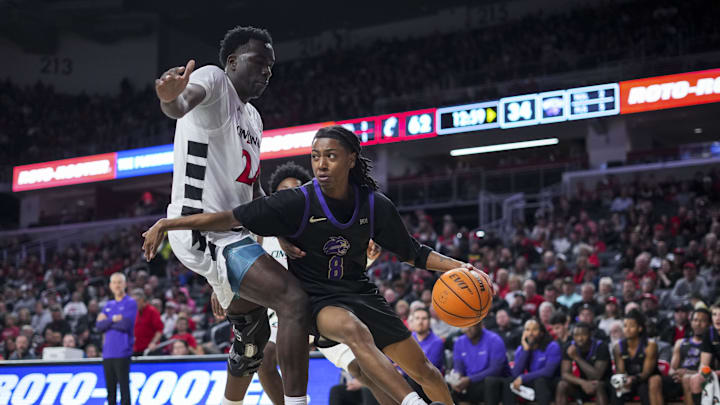 Nov 3, 2025; Cincinnati, Ohio, USA;  Western Carolina Catamounts guard Tahlan Pettway (8) dribbles the ball against Cincinnati Bearcats forward Tyler McKinley (24) in the second half at Fifth Third Arena.