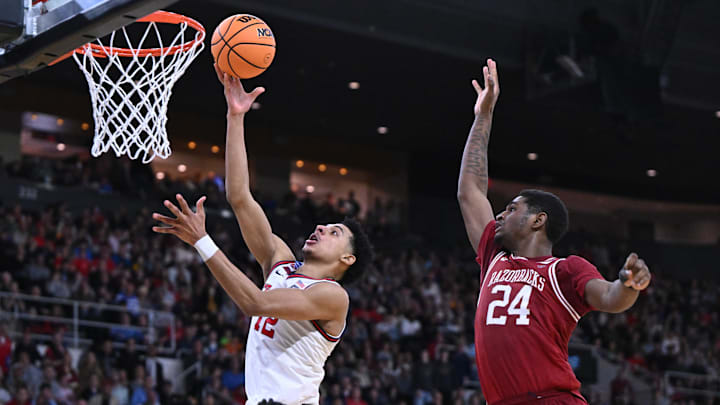 Mar 22, 2025; Providence, RI, USA; St. John's Red Storm guard RJ Luis Jr. (12) shoots against Arkansas Razorbacks forward Billy Richmond III (24) during the second half of a second round men’s NCAA Tournament game at Amica Mutual Pavilion. Mandatory Credit: Brian Fluharty-Imagn Images