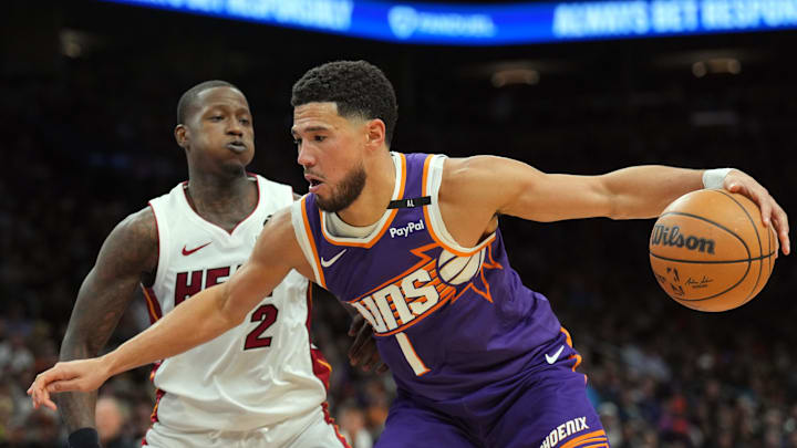Phoenix Suns guard Devin Booker dribbles against Miami Heat guard Terry Rozier. Phoenix Suns guard Devin Booker dribbles against Miami Heat guard Terry Rozier.