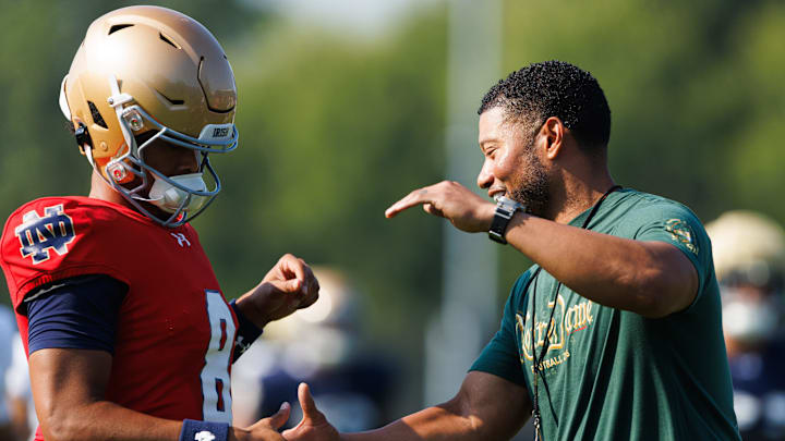 Notre Dame head coach Marcus Freeman, right, greets quarterback Kenny Minchey (8) during a football practice at Irish Athletic Center on Wednesday, Aug. 6, 2025, in South Bend.