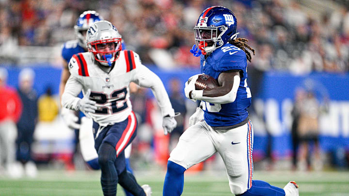 Aug 21, 2025; East Rutherford, New Jersey, USA; New York Giants running back Jonathan Ward (23) runs for a touchdown chased by New England Patriots safety Marcus Epps (22) during the third quarter against the New England Patriots at MetLife Stadium. Mandatory Credit: Mark Smith-Imagn Images