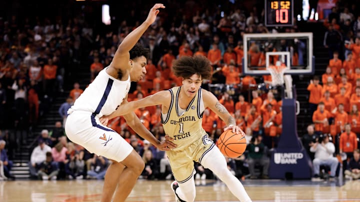 Feb 8, 2025; Charlottesville, Virginia, USA; Georgia Tech Yellow Jackets guard Naithan George (1) dribbles the ball while Virginia Cavaliers forward Anthony Robinson (21) defends in the first half at John Paul Jones Arena. Mandatory Credit: Amber Searls-Imagn Images Feb 8, 2025; Charlottesville, Virginia, USA; Georgia Tech Yellow Jackets guard Naithan George (1) dribbles the ball while Virginia Cavaliers forward Anthony Robinson (21) defends in the first half at John Paul Jones Arena. Mandatory Credit: Amber Searls-Imagn Images